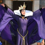 The Evil Queen blocking guests with her cape
