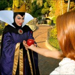 The Evil Queen offers an apple to a guest
