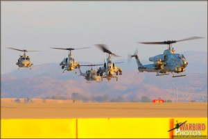 AH-1W Cobras hover in to their landing spots followed by UH-1N Hueys