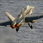 An F/A-18c Hornet is launched off the deck of the USS Abraham Lincoln Aircraft Carrier