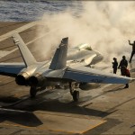 An F/A-18C Hornet preps for being launched off the deck of the USS Abraham Lincoln Aircraft Carrier