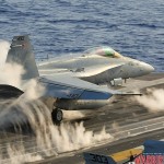 An F/A-18C Hornet launches off the USS Abraham Lincoln Aircraft Carrier