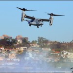 An MV-22 Osprey performs a demo over the water at the Centennial of Naval Aviation Celebration 2011