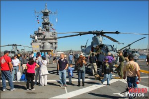 Civilians tour the flight deck of the USS Peleliu US Marine Amphibious Assault Carrier