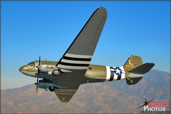 A Douglas C-47B Skytrain banks over the Orange County El Toro mountains
