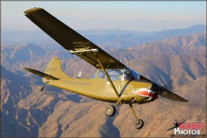 A Cessna O-1E Bird Dog banks over the El Toro, California mountains