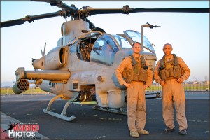 The pilots of the US Marine AH-1Z Viper pose with their helicopter before taking off