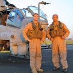 The pilots of the US Marine AH-1Z Viper pose with their helicopter before taking off