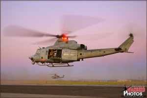 A Bell UH-1Y Venom lifts into the air with a Bell AH-1Z Viper heading off in the rear at the MCAS El Toro / Great Park airshow
